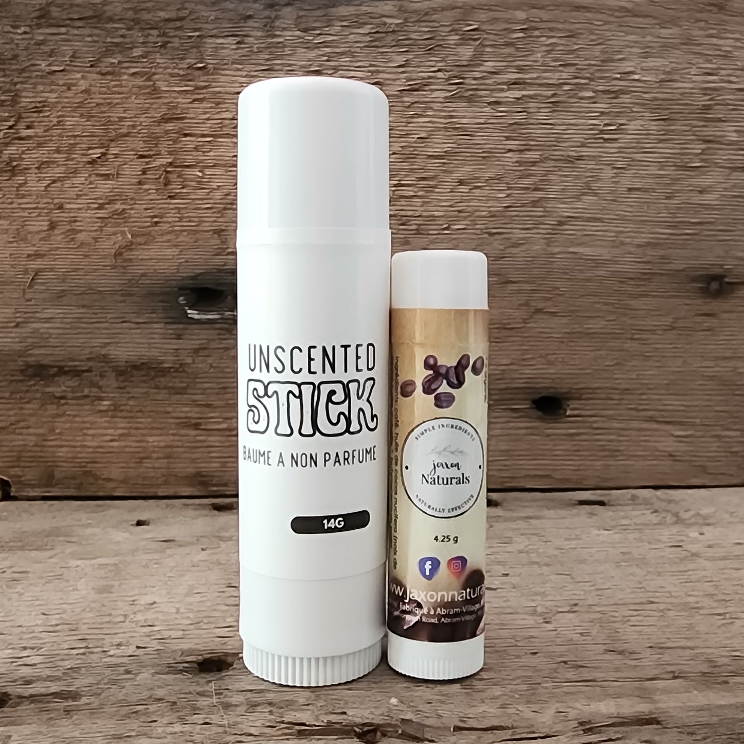 Jaxon Naturals Unscented Jumbo Balm Stick displayed with regular sized Coffee Lip Balm on rustic barn board