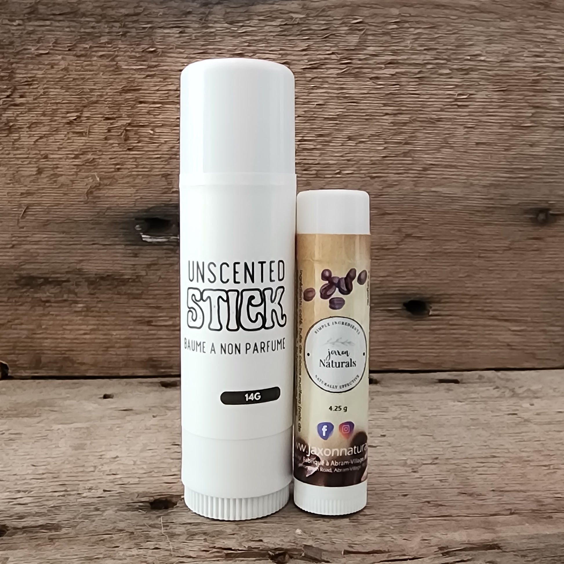 Jaxon Naturals Unscented Jumbo Balm Stick displayed with regular sized Coffee Lip Balm on rustic barn board