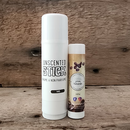 Jaxon Naturals Unscented Jumbo Balm Stick displayed with regular sized Coffee Lip Balm on rustic barn board