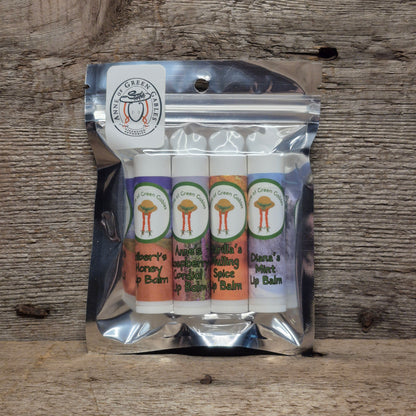 Jaxon Naturals Anne of Green Gables lip balm collection with four PEI-inspired handcrafted lip balms displayed on rustic barn board.