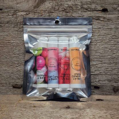 Jaxon Naturals Kids Lip Balm Collection featuring four handcrafted lip balms displayed on rustic barn board.