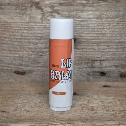 Jaxon Naturals Maple Jumbo Balm Stick displayed on rustic barn board.
