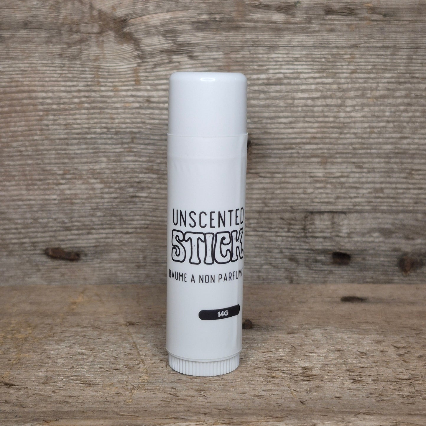 Jaxon Naturals Unscented Jumbo Balm Stick displayed on rustic barn board.