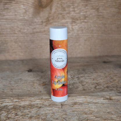 Jaxon Naturals limited edition apple lip balm displayed on rustic barn board.
