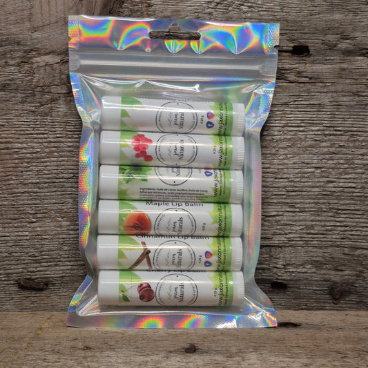Jaxon Naturals Signature Lip Balm Discovery Collection featuring six full-size handcrafted lip balms displayed on rustic barn board